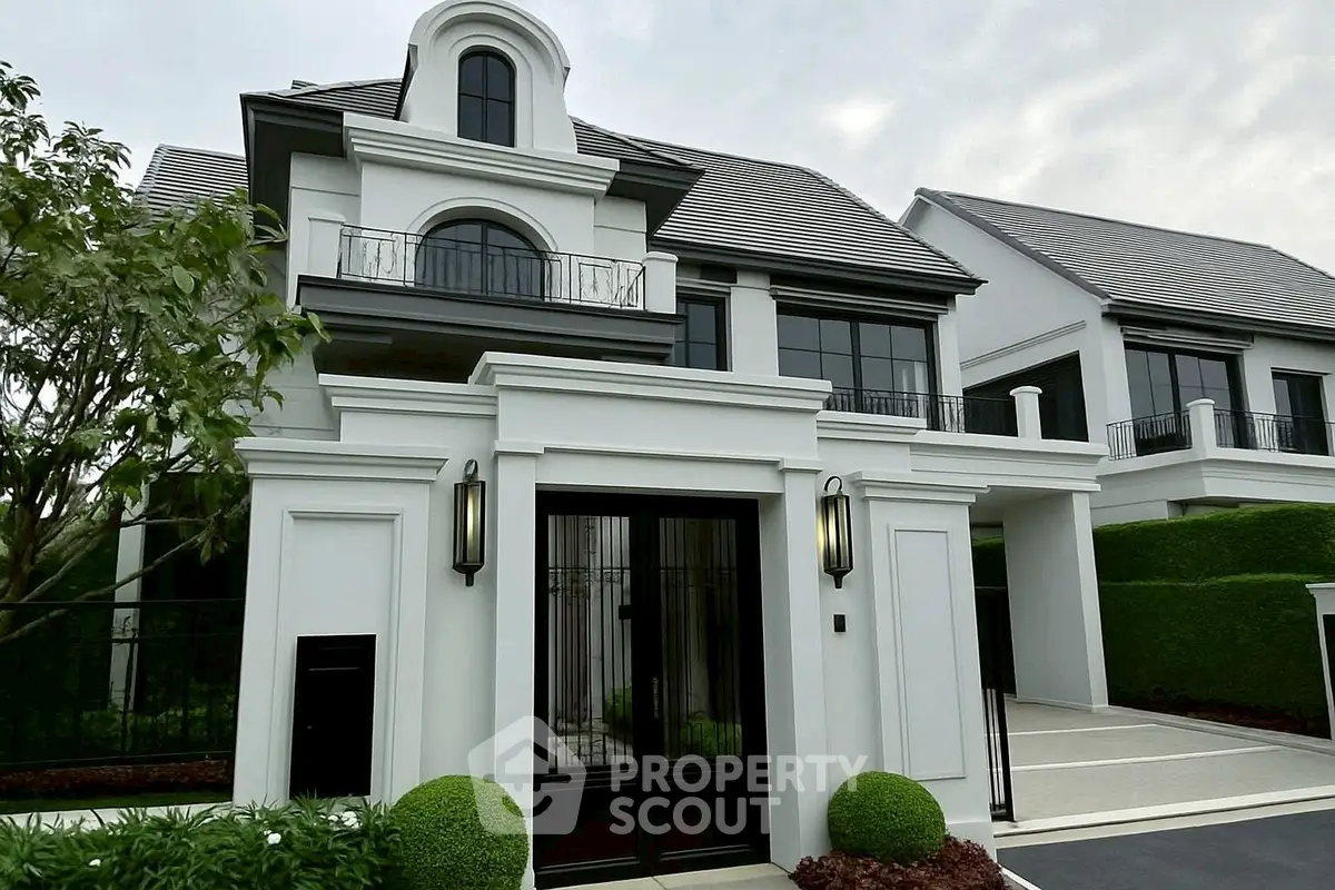 Elegant modern house with classic architectural elements and lush landscaping.