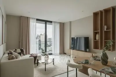 Modern living room with city view, stylish decor, and large windows.