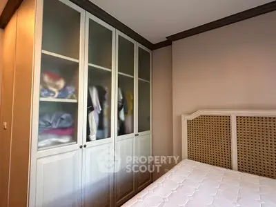 Cozy bedroom with built-in wardrobe and stylish headboard