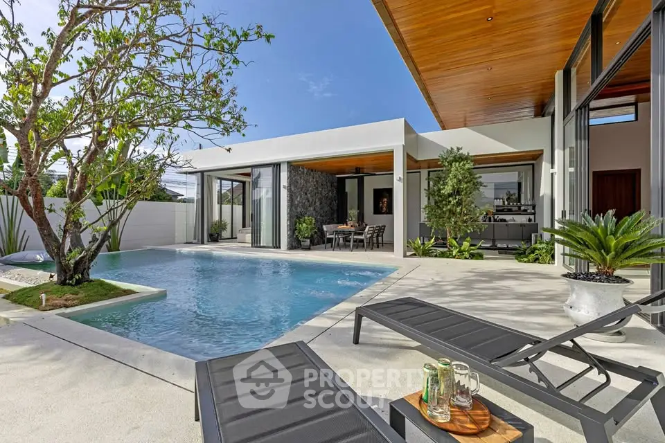 Luxurious modern villa with private pool and stylish outdoor lounge area, perfect for relaxation and entertainment.