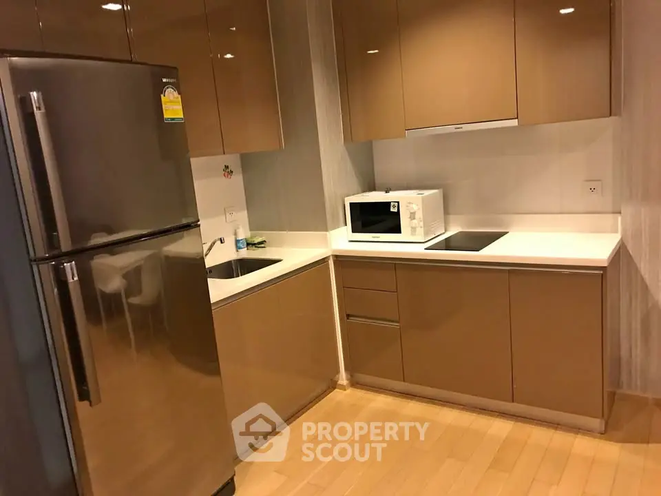 Modern kitchen with sleek cabinetry and stainless steel fridge