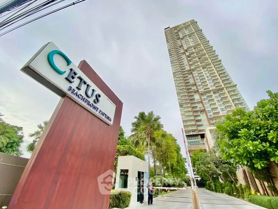 Luxurious beachfront condominium with modern architecture and lush greenery in prime Pattaya location.