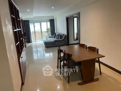 Spacious living room with elegant dining area and cozy seating, perfect for modern family living.