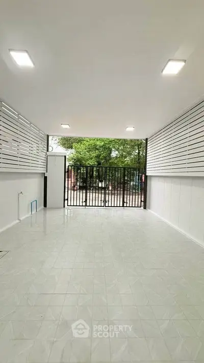 Spacious modern garage with sleek design and ample natural light, perfect for secure parking or storage.