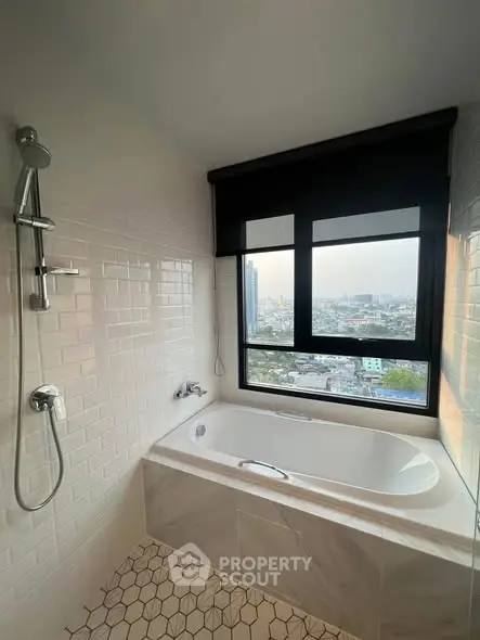 Modern bathroom with city view, featuring a bathtub and shower setup.