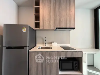 Modern kitchen with sleek cabinetry, built-in appliances, and stylish design in a contemporary apartment.