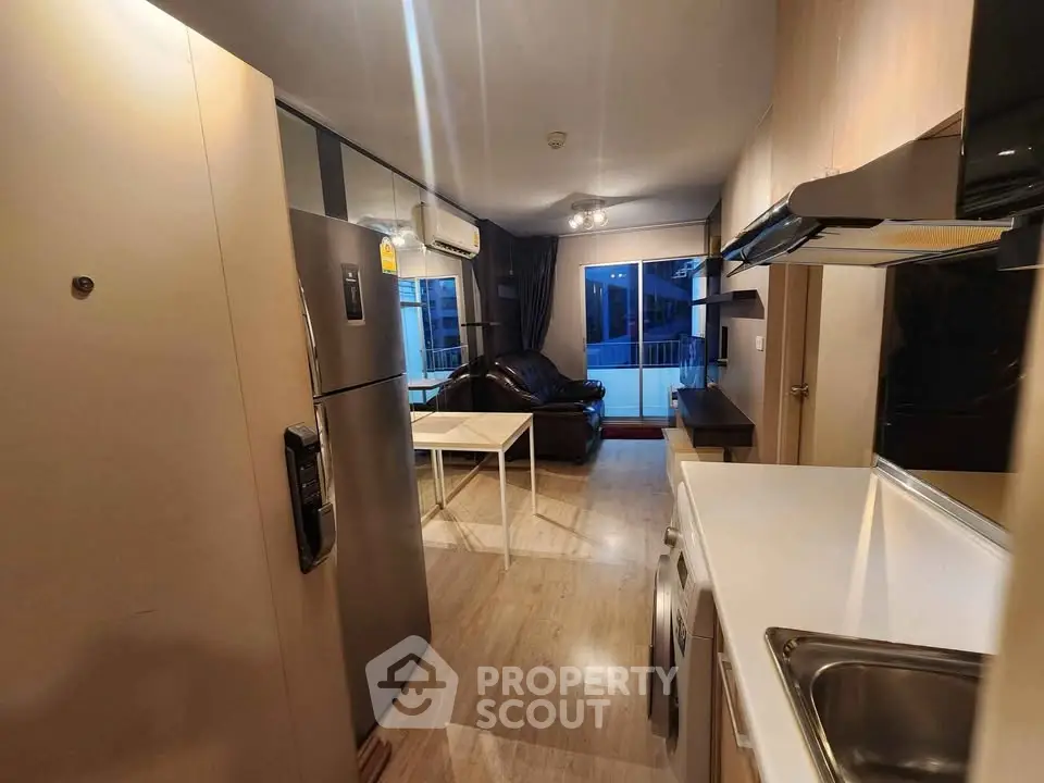 Modern apartment interior with open kitchen and cozy living area