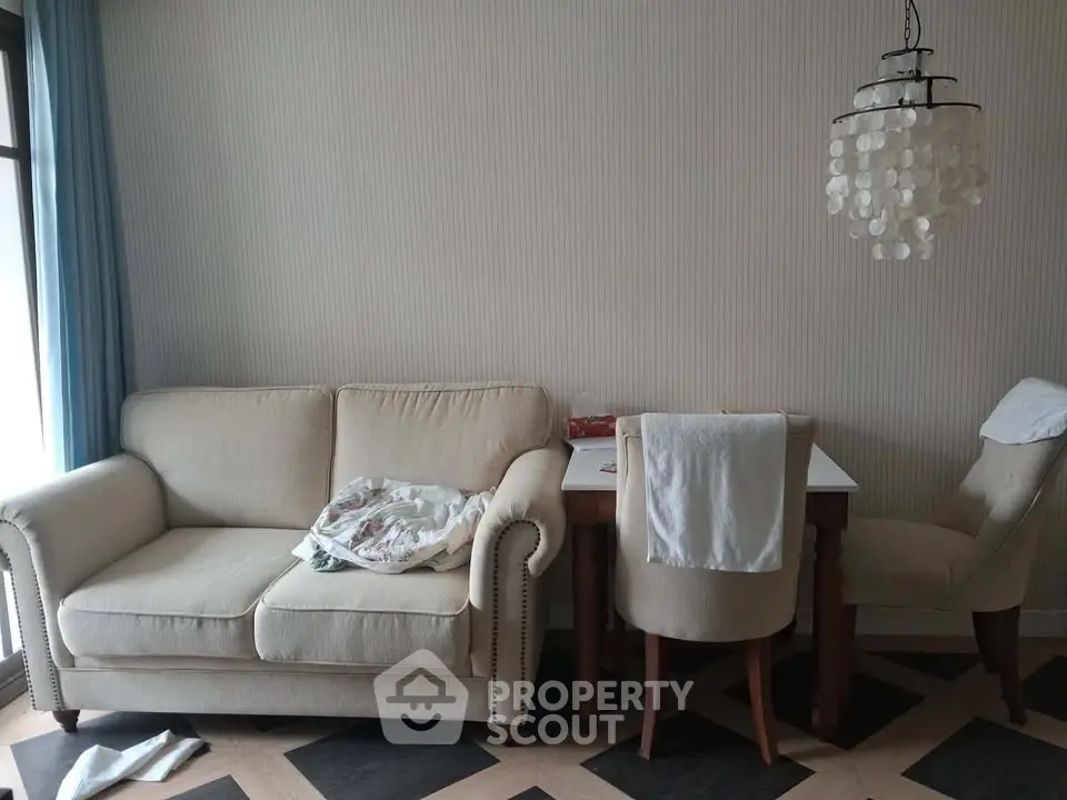 Cozy living room with elegant beige sofa and chic dining area