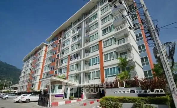 Modern condominium building with multiple floors and large windows, ideal for urban living.