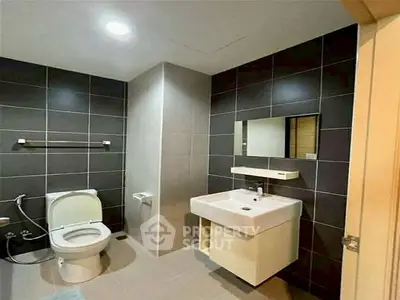 Modern bathroom with sleek design and dark tile accents