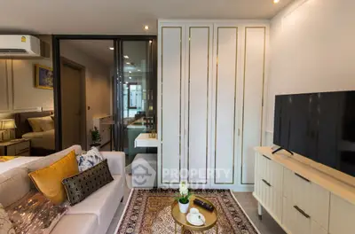 Modern living room with elegant decor, featuring a cozy sofa, stylish TV stand, and decorative rug.