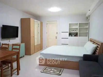 Cozy studio apartment with modern furnishings and ample storage space.