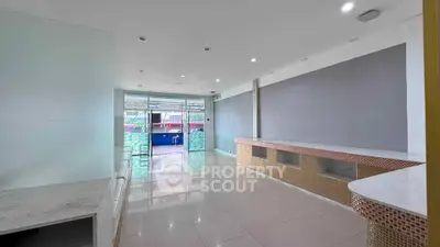 Spacious modern interior with large windows and sleek design, perfect for versatile use.