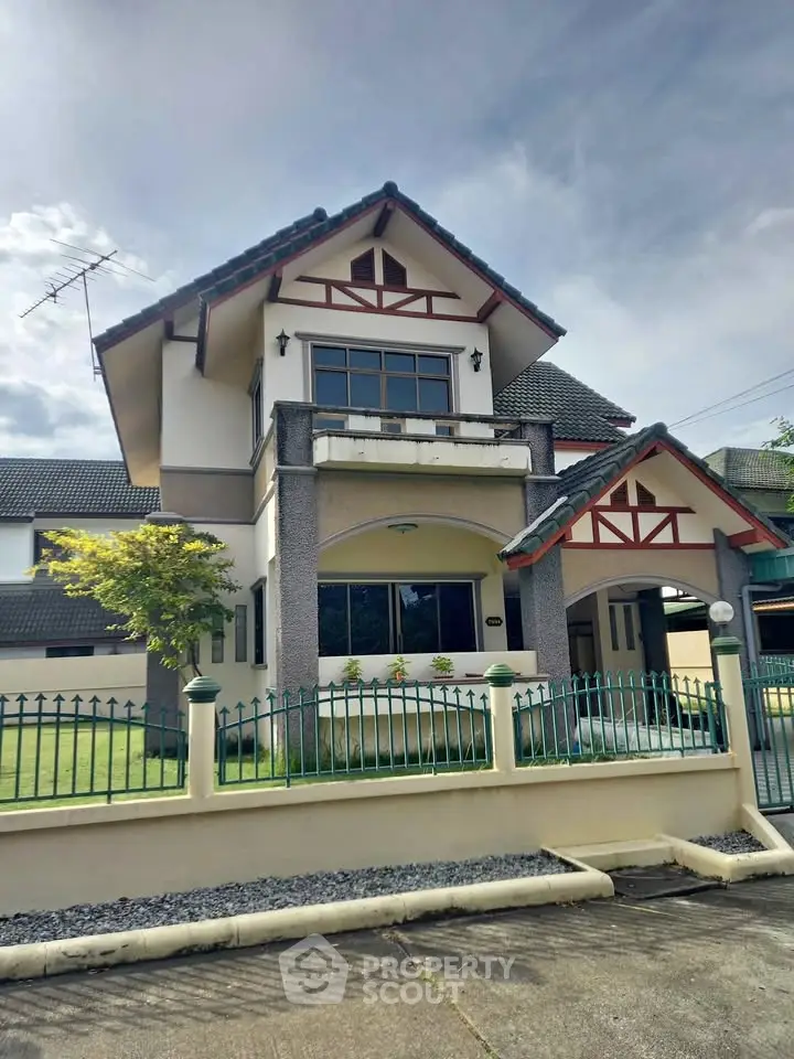 Charming two-story house with unique architectural design and spacious front yard.