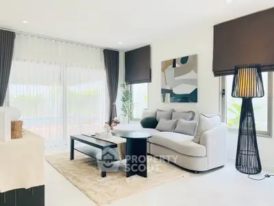 Elegant living room with modern decor and large windows offering natural light.