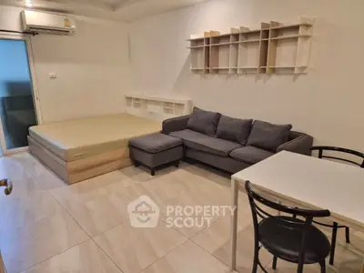 Modern studio apartment with cozy living area and stylish furniture