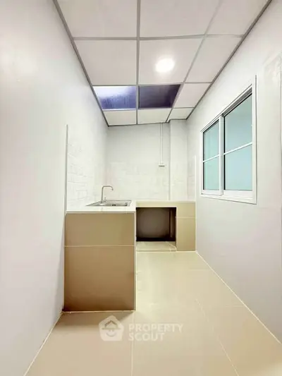 Modern minimalist kitchen with sleek design and ample natural light