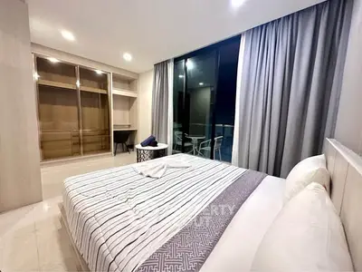 Spacious modern bedroom with large windows and stylish decor