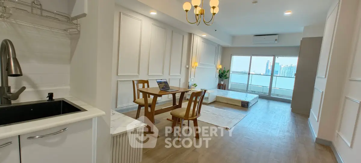 Spacious modern living room with city view, featuring elegant decor and natural light.