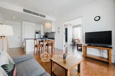 Spacious living room with modern decor and open kitchen layout