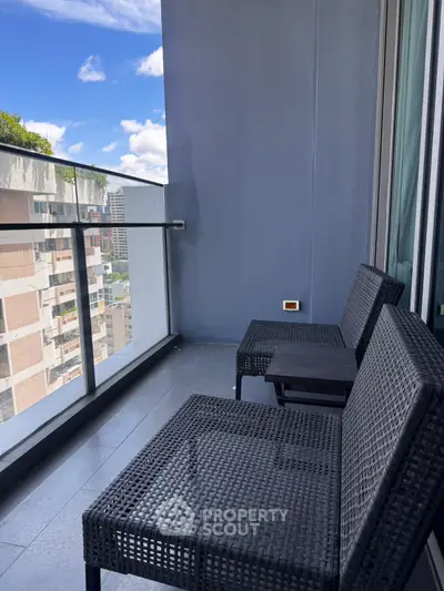 Modern balcony with stylish seating and city view, perfect for relaxation and enjoying the skyline.