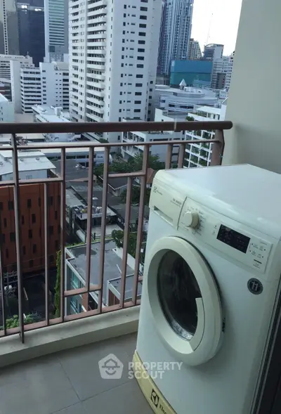 High-rise balcony with city view and washing machine, perfect for urban living convenience.