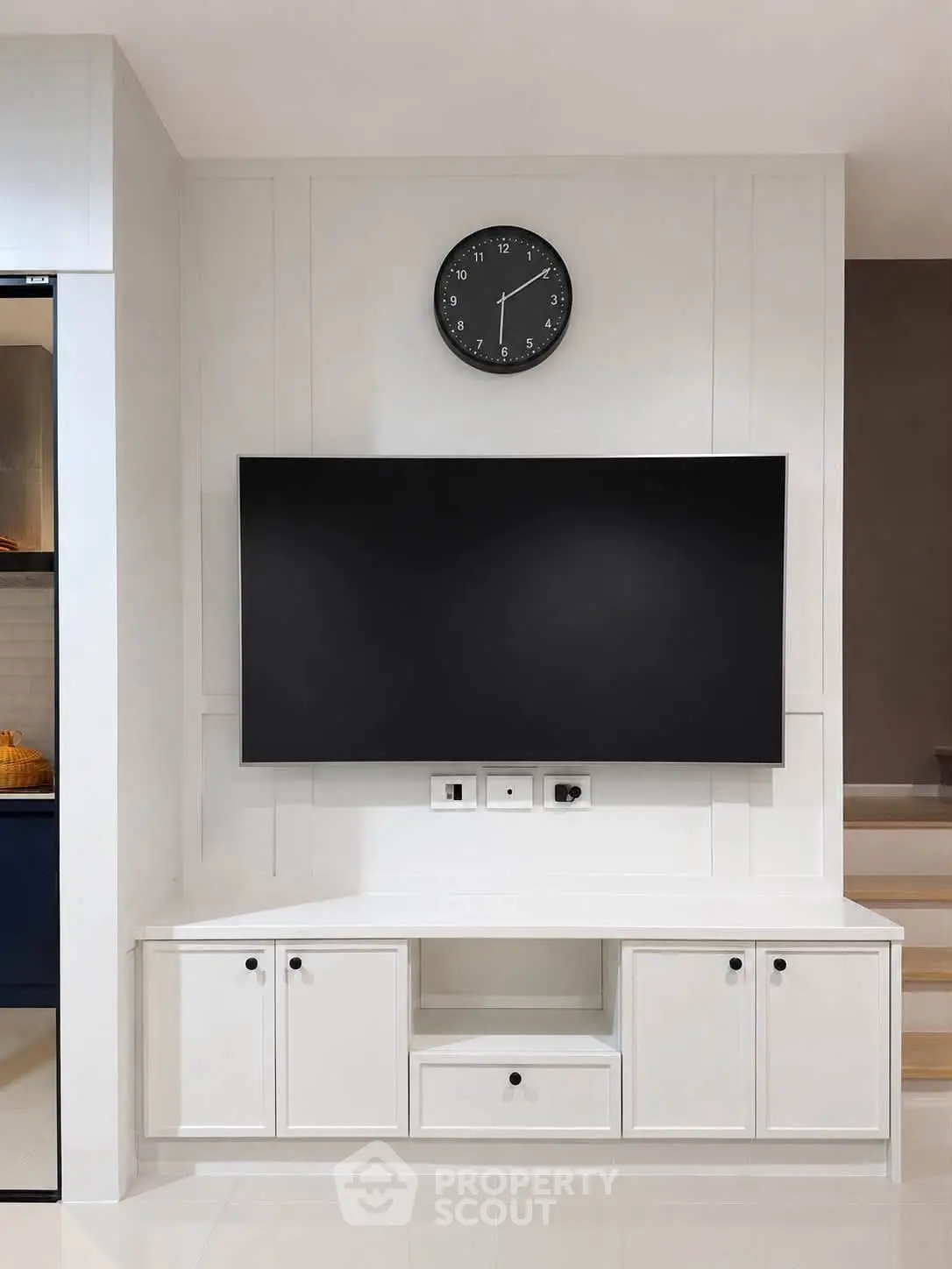 Modern living room with sleek TV setup and stylish cabinetry