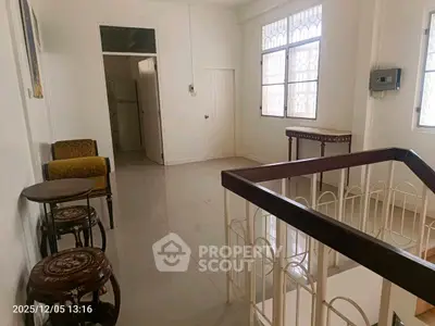 Bright hallway with elegant furniture and large windows in a modern home