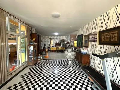 Spacious living room with checkered floor and treadmill, perfect for relaxation and fitness.