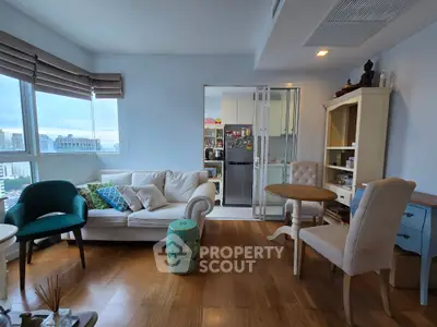 Charming living room with cozy seating and modern decor, featuring a view of the city skyline.