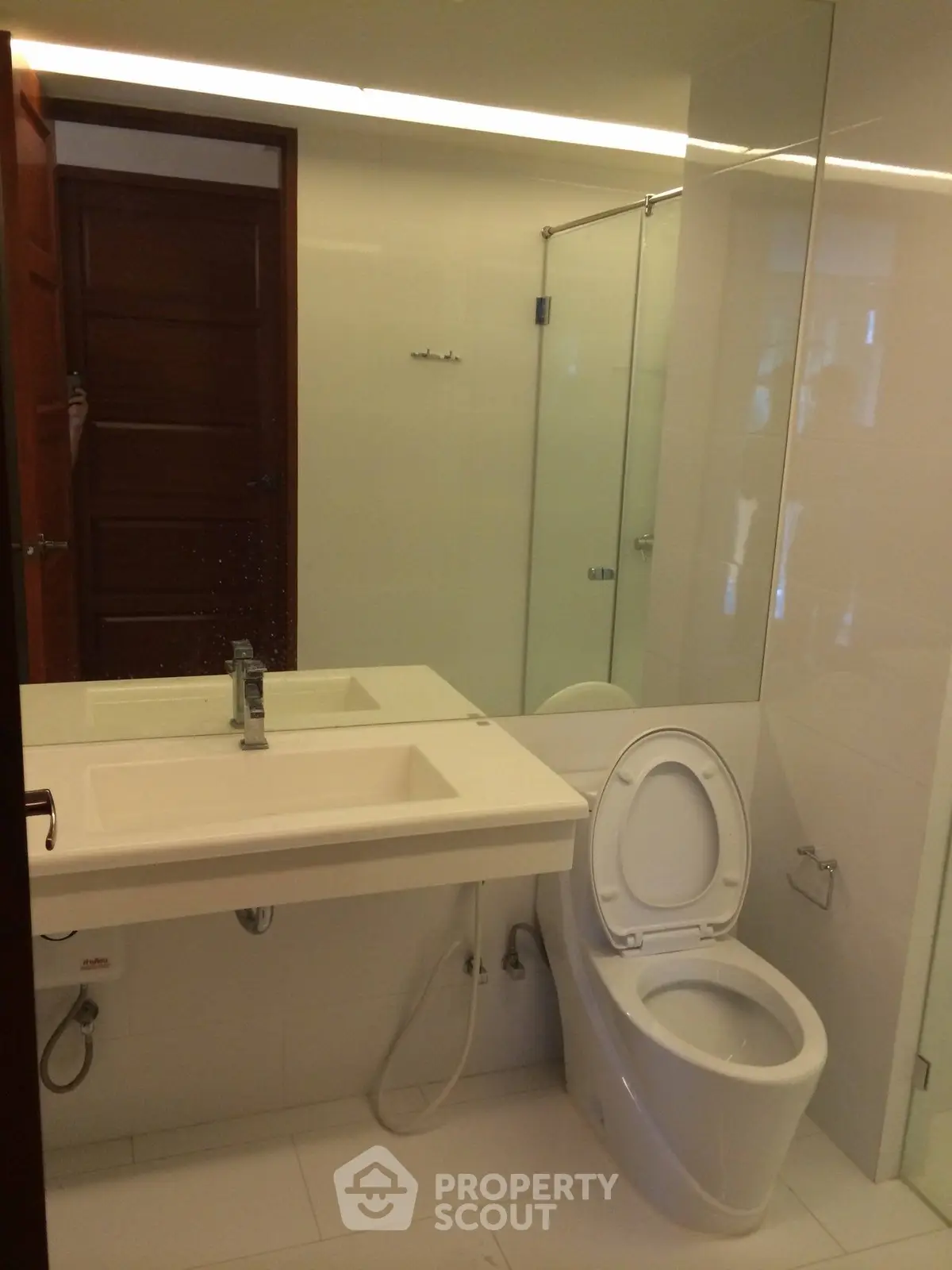 Modern bathroom with sleek fixtures and glass shower enclosure