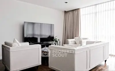 Elegant living room with modern furniture and large TV, featuring floor-to-ceiling windows and stylish decor.