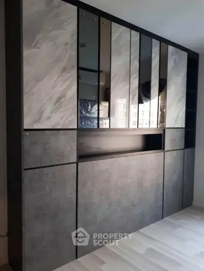 Modern built-in storage unit with sleek design and mirrored panels
