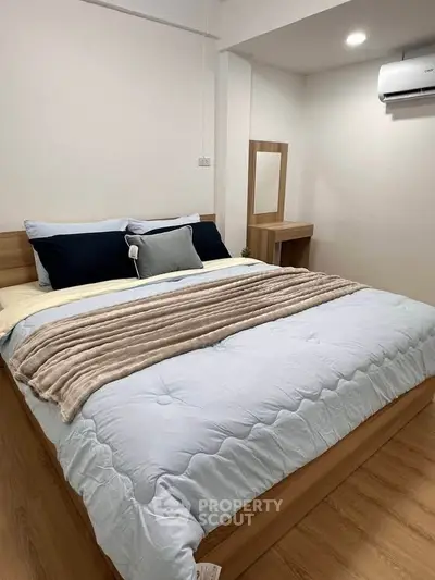 Cozy bedroom with modern wooden furniture and plush bedding