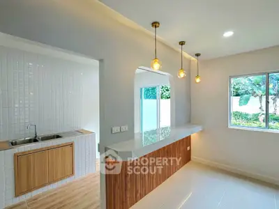 Modern kitchen with open layout and stylish lighting in a bright, airy home.