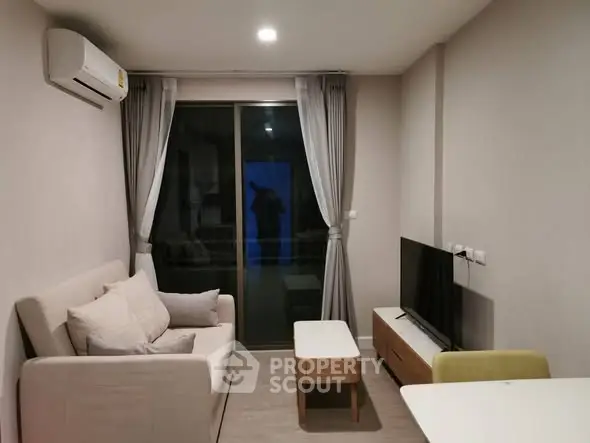 Modern living room with cozy sofa and sleek TV setup in stylish apartment.