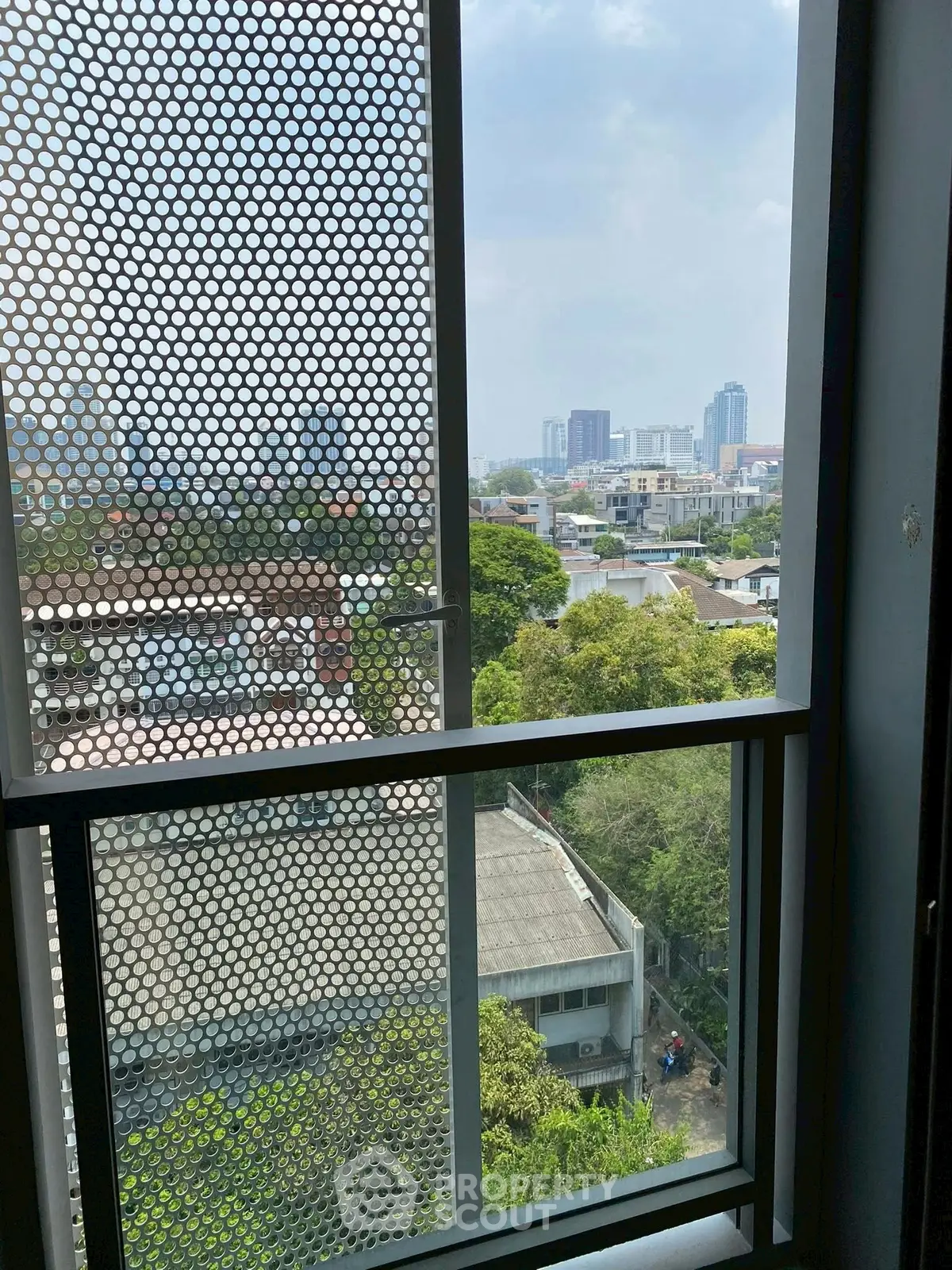 Stunning cityscape view from a modern apartment window, showcasing urban living.
