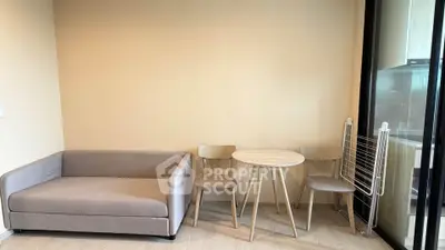 Modern living room with cozy sofa and dining set in a stylish apartment.