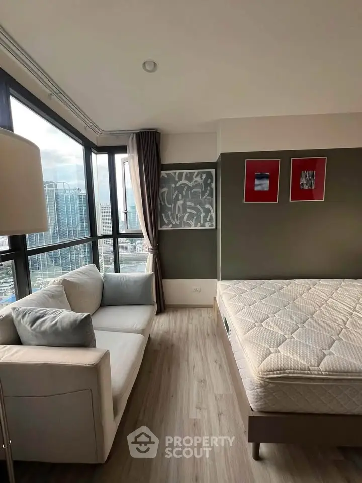 Modern bedroom with large windows offering stunning city views and stylish decor.