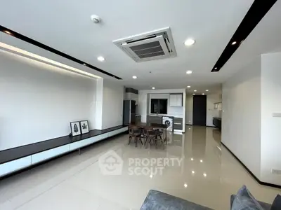 Spacious modern living room with open kitchen and sleek design