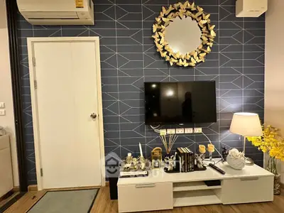 Stylish living room with modern decor, wall-mounted TV, and elegant lighting for a cozy ambiance.