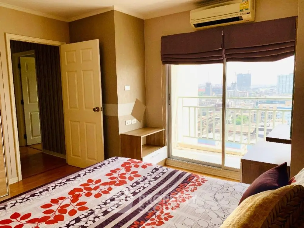 Bright bedroom with balcony and city view in modern apartment