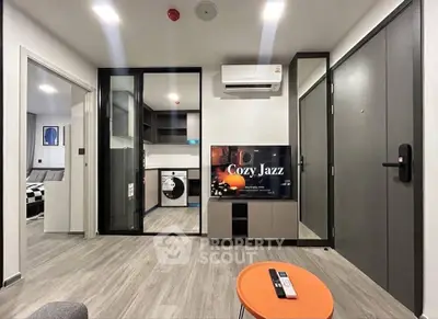 Modern living room with sleek design, featuring a glass partition, air conditioning, and stylish flooring.