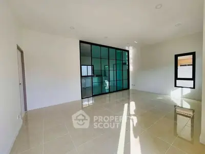 Spacious empty room with large windows and glossy tiled floor