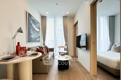 Modern living room with stylish decor and natural light in a contemporary apartment.