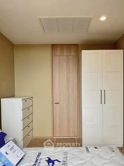 Modern bedroom with sleek wardrobe and chest of drawers