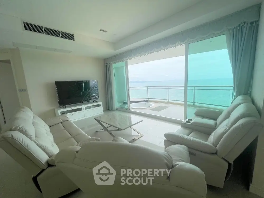 Luxurious living room with stunning ocean view and spacious balcony in modern apartment.