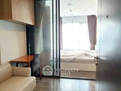 Modern bedroom with glass partition and cozy furnishings in a stylish apartment.