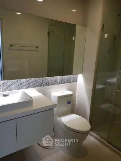 Modern bathroom with sleek fixtures and glass shower enclosure