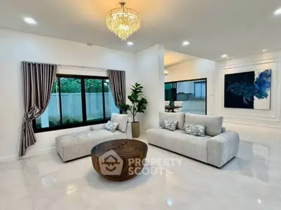 Luxurious modern living room with elegant chandelier and stylish decor